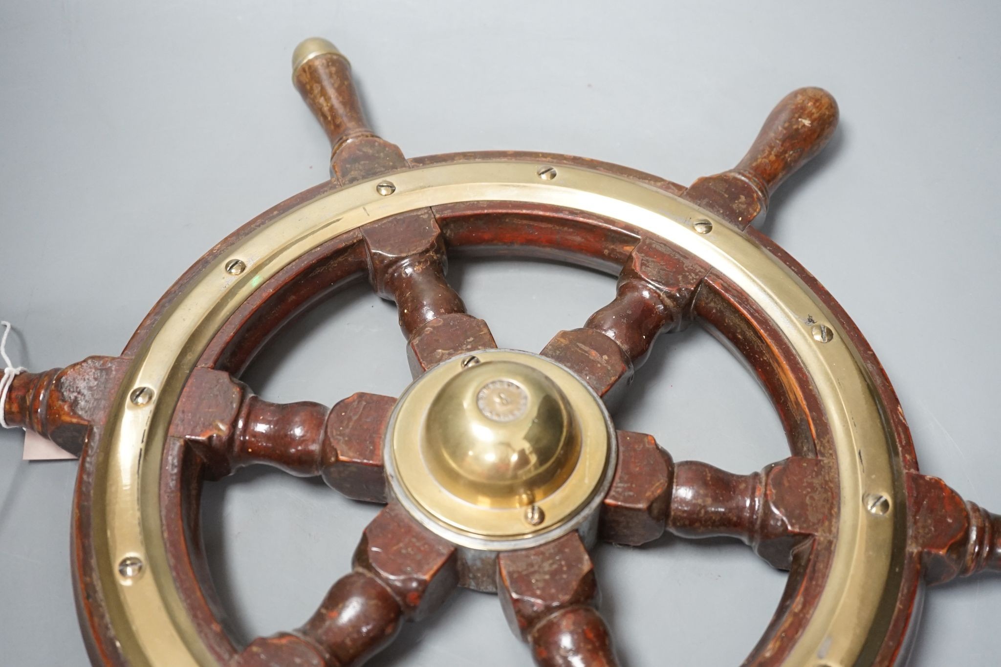 A hardwood and brass mounted Ship's wheel, signed Lawrence Simpson 50cm